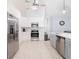 Spacious kitchen with stainless steel appliances, white cabinets, and a gray backsplash at 382 Florian Way, Spring Hill, FL 34609