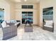 Covered patio features wicker furniture, tile flooring, and sliding glass doors at 382 Florian Way, Spring Hill, FL 34609