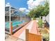 Screened-in pool area with patio, tropical foliage, and plenty of room for entertaining at 382 Florian Way, Spring Hill, FL 34609