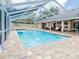 Inviting screened-in pool with lounge area, perfect for relaxation and outdoor entertaining at 382 Florian Way, Spring Hill, FL 34609