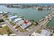 Aerial view of waterfront home with a private dock and lush landscaping in a coastal community at 399 161St Ave, Redington Beach, FL 33708