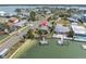 Waterfront home featuring a private dock, lush landscaping, and stunning views of the surrounding bay area at 399 161St Ave, Redington Beach, FL 33708