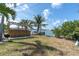 A serene backyard with a private dock and an outdoor kitchen, perfect for waterfront entertaining at 399 161St Ave, Redington Beach, FL 33708