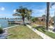 A picturesque backyard featuring a private dock, waterfront views, and outdoor seating area at 399 161St Ave, Redington Beach, FL 33708