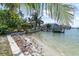 A sandy beach and private dock offering direct waterfront access and stunning views at 399 161St Ave, Redington Beach, FL 33708