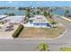 A charming waterfront home on a sunny day, featuring well-maintained landscaping at 399 161St Ave, Redington Beach, FL 33708