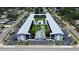 Bird's eye view of the condo complex featuring a serene pool and shuffleboard area amidst tropical greenery at 4050 4Th N St # 205, St Petersburg, FL 33703