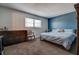 Cozy bedroom with neutral carpet, a blue accent wall, and a comfortable queen-sized bed at 4050 4Th N St # 205, St Petersburg, FL 33703