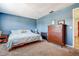 Comfortable bedroom with blue walls, carpet, and dresser, creating a relaxing atmosphere at 4050 4Th N St # 205, St Petersburg, FL 33703
