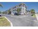 Exterior shot of condo complex with palm trees and parking at 4050 4Th N St # 205, St Petersburg, FL 33703