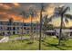 Beautiful condo complex featuring a green space, clubhouse, and palm trees at 4050 4Th N St # 205, St Petersburg, FL 33703