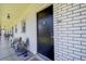 White brick hallway featuring chairs and unit number 205 at 4050 4Th N St # 205, St Petersburg, FL 33703