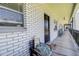 White brick hallway featuring chairs, plants, and natural light at 4050 4Th N St # 205, St Petersburg, FL 33703