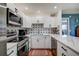 Modern kitchen with white cabinetry, stainless steel appliances, and a colorful tile backsplash at 4050 4Th N St # 205, St Petersburg, FL 33703