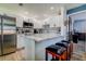 Bright kitchen featuring white cabinets, stainless steel appliances, and a stylish tiled backsplash at 4050 4Th N St # 205, St Petersburg, FL 33703