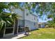 Backyard view of home showcasing grill on patio and lush lawn at 4203 W Cleveland St, Tampa, FL 33609