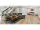 Finished basement with a large gray sectional sofa, wood floors, and a sliding barn door at 4203 W Cleveland St, Tampa, FL 33609