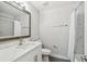 Neutral bathroom featuring a single sink vanity with a shower-tub combo and gray tile flooring at 4203 W Cleveland St, Tampa, FL 33609