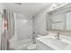 Stylish bathroom featuring modern fixtures, marble-look tile, and a shower-tub combination at 4203 W Cleveland St, Tampa, FL 33609