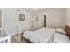 Bedroom featuring wood floors, a light fixture, and a view of the ensuite and walk-in closet at 4203 W Cleveland St, Tampa, FL 33609