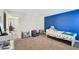Bright bedroom featuring a blue accent wall, a comfortable bed, and bookcases at 4203 W Cleveland St, Tampa, FL 33609