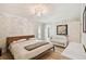 Bedroom with a stylish light fixture, wood floors, and a crib at 4203 W Cleveland St, Tampa, FL 33609