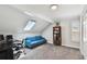 Versatile bonus room with skylight, workspace, and a comfortable blue sofa at 4203 W Cleveland St, Tampa, FL 33609