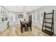 Bright dining room with designer light fixture, wood floors, and custom-built in shelving at 4203 W Cleveland St, Tampa, FL 33609
