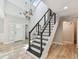 Bright entryway with a modern staircase, stylish light fixtures, and light-colored wood floors at 4203 W Cleveland St, Tampa, FL 33609