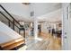 Bright open-concept entryway features modern staircase and luxury vinyl plank flooring leading to the kitchen at 4203 W Cleveland St, Tampa, FL 33609