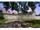 Charming home featuring a well-manicured lawn, a two-car garage, and a beautiful shade tree at 4203 W Cleveland St, Tampa, FL 33609