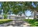 Charming single-story home featuring a wide driveway, lush lawn and mature tree at 4203 W Cleveland St, Tampa, FL 33609