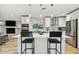 Bright kitchen with a large island, bar stool seating, stainless appliances, and decorative backsplash at 4203 W Cleveland St, Tampa, FL 33609