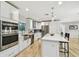 Updated kitchen with stainless steel appliances, white cabinetry, and quartz countertops with a large sink at 4203 W Cleveland St, Tampa, FL 33609