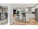 Modern kitchen with bright countertops, stainless appliances, kitchen island with seating, and fireplace at 4203 W Cleveland St, Tampa, FL 33609