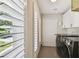 Bright laundry room featuring modern washer/dryer, storage cabinets, and plantation shutters at 4203 W Cleveland St, Tampa, FL 33609