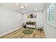 Bright playroom area with wood floors, decorative wall panels, modern chandelier, and storage at 4203 W Cleveland St, Tampa, FL 33609