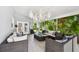 Spacious sunroom with outdoor seating, lush greenery, and stylish pendant lighting at 4203 W Cleveland St, Tampa, FL 33609