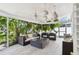 Inviting sunroom with wicker furniture, tropical plants, and decorative pendant lights at 4203 W Cleveland St, Tampa, FL 33609