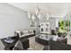 Comfortable sunroom with wicker seating, outdoor view, and elegant pendant lighting at 4203 W Cleveland St, Tampa, FL 33609