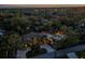 Aerial view showcases lush, private property with a stunning pool and backyard bar amid mature trees at twilight at 4301 S Lockwood Ridge Rd, Sarasota, FL 34231