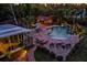Aerial view of a backyard oasis featuring a beautiful pool, lush landscaping, and an inviting outdoor bar area at 4301 S Lockwood Ridge Rd, Sarasota, FL 34231