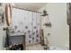 Bathroom with sink, shower with patterned curtain, and wall-mounted plant decor at 4301 S Lockwood Ridge Rd, Sarasota, FL 34231