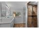 Bright bathroom featuring dual sinks, a window, and a tiled walk-in shower at 4301 S Lockwood Ridge Rd, Sarasota, FL 34231