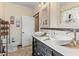 Bathroom featuring a double sink vanity, a framed mirror, and modern fixtures at 4301 S Lockwood Ridge Rd, Sarasota, FL 34231