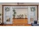 Bright bonus room features hardwood floors, double french doors, and view into the living room at 4301 S Lockwood Ridge Rd, Sarasota, FL 34231