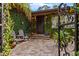 Charming courtyard with brick pavers, lush greenery, and seating area at 4301 S Lockwood Ridge Rd, Sarasota, FL 34231