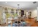 Bright dining room with wood floors, stylish curtains, and an elegant chandelier offering a welcoming atmosphere at 4301 S Lockwood Ridge Rd, Sarasota, FL 34231
