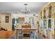 Bright dining room features wood floors, a chandelier, and a large window with colorful floral curtains at 4301 S Lockwood Ridge Rd, Sarasota, FL 34231