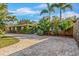 Well-maintained home exterior with mature landscaping, palm trees, and a brick driveway at 4301 S Lockwood Ridge Rd, Sarasota, FL 34231